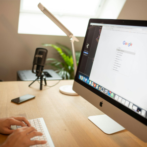 Person using computer with Google search - SEO